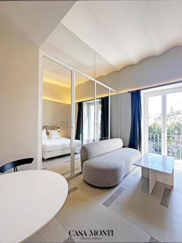 a living room with a couch and a table at CASA MONTI Sherry Suites in Jerez de la Frontera