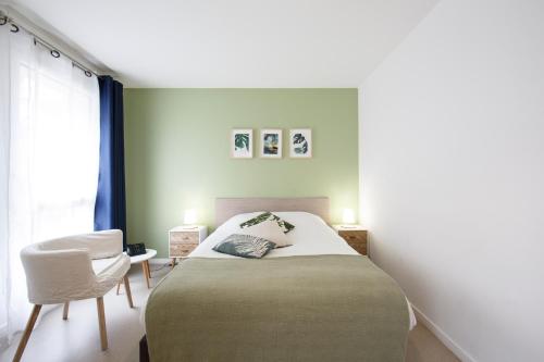 a bedroom with a bed and a chair at MAISON SAINT CHARLES - ASSOCIATION HABITAT et HUMANISME ILE DE FRANCE in Paris