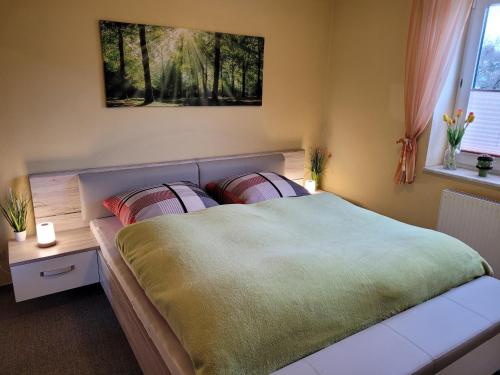 a bedroom with a large bed with two pillows at Ferienwohnung Panorama in Schmalkalden