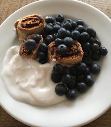 a plate of food with blueberries and whipped cream at Torres De Selma - Eco Resort in El Pla de Manlleu