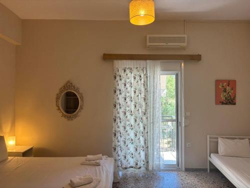 a bedroom with a bed and a window with a windowvisor at Galazia Nera Apartments in Áyios Andréas Messinias