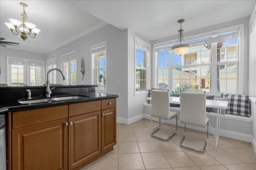 a kitchen with a sink and a table and chairs at 3 Bedrooms 2 Bathrooms Reunion 7521-104 Md in Kissimmee