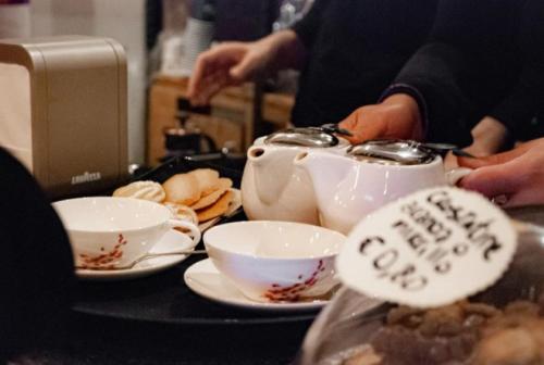 a table with bowls and a teapot on top of it at Lux Beach Apartment BLACK in Lido di Ostia