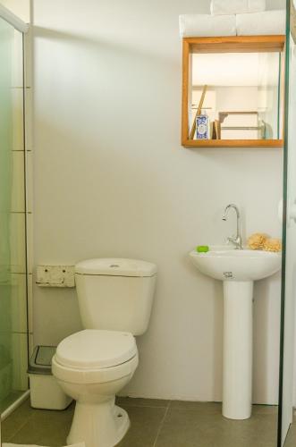 a bathroom with a toilet and a sink at Alma Brava in Itajaí