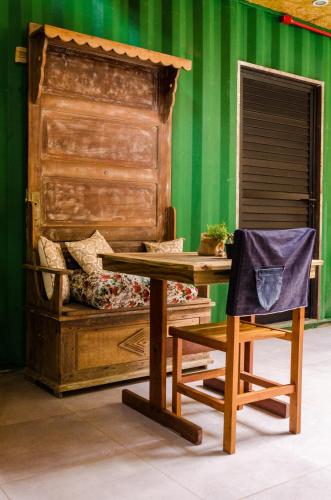 a wooden table and a chair next to a bed at Alma Brava in Itajaí
