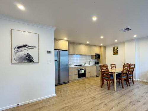 a kitchen and dining room with a table and chairs at NO PARTY ALLOWED, Entire Brand New 3 bedroom townhouse, free unlimited fibre wifi and free parking in Wellington