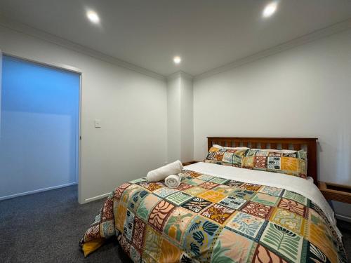 a bedroom with a bed and a large window at NO PARTY ALLOWED, Entire Brand New 3 bedroom townhouse, free unlimited fibre wifi and free parking in Wellington