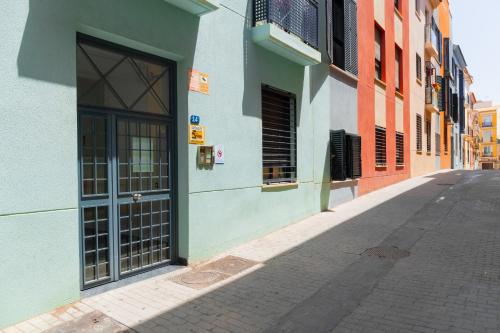 an empty alley with a door on a building at C15 - Charming Modern Studio in the Centre in Málaga
