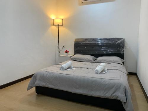 a bedroom with a large bed with two pillows at Guesthouse With Seaview Anekayangan Tawau Guesthouse in Tawau