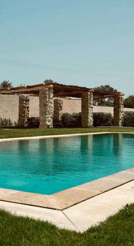 a swimming pool in front of a building at Domaine El Htouba in Korba