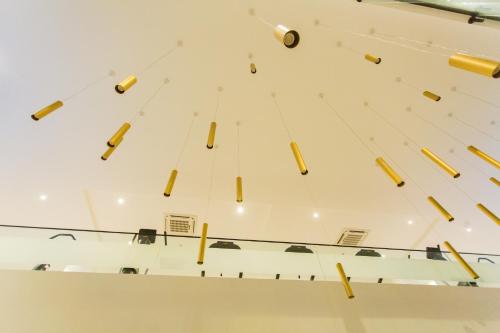 a group of yellow chandeliers hanging from a ceiling at Accra Luxury Apartments at Embassy Gardens in Accra
