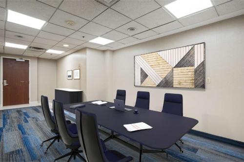 a conference room with a black table and chairs at Hampton Inn Ridgefield Park in Ridgefield Park