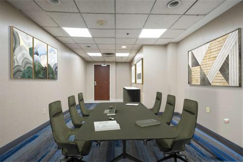a conference room with a green table and chairs at Hampton Inn Ridgefield Park in Ridgefield Park