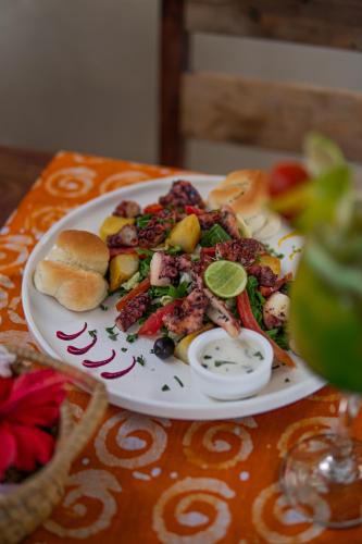 a plate of food with a salad and bread on a table at Mr Kahawa in Paje