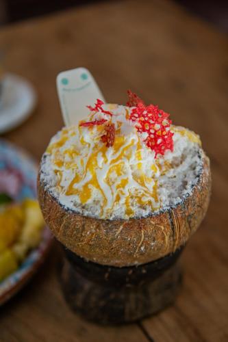 a cake sitting on top of a wooden table at Mr Kahawa in Paje