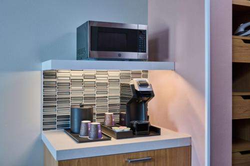 a kitchen with a coffee maker and a microwave at Hilton Garden Inn Anchorage in Anchorage
