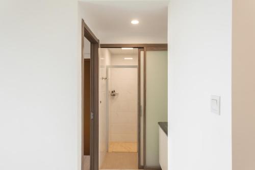 a door leading into a bathroom with a shower at Calma 2BR II at Skyhouse Apartment in Samporo
