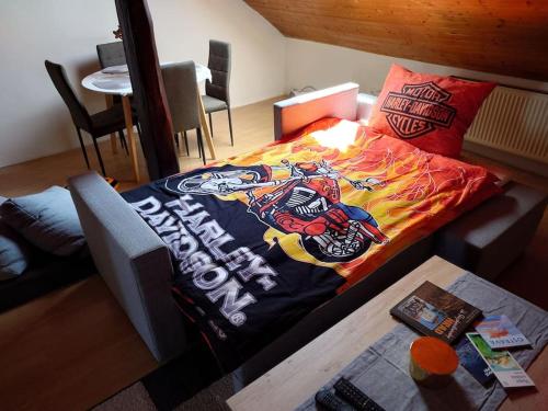 a bed in a living room with aamed at Apartmán Zukalka 2kk in Vítkovice