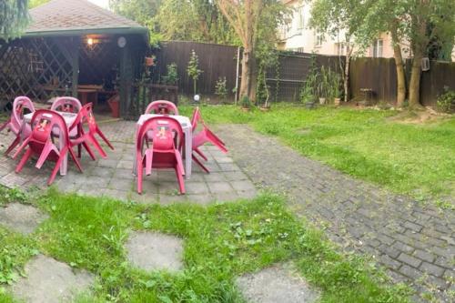 a group of pink tables and chairs in a yard at Apartmán Zukalka 2kk in Vítkovice