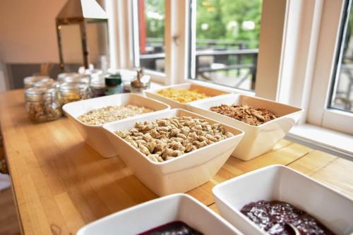a table with four bowls of different types of food at Hotel Ullinge in Eksjö