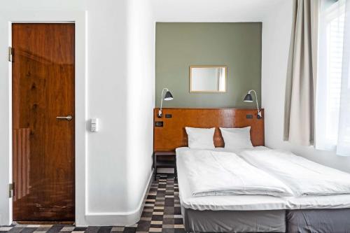 En eller flere senge i et værelse på Hotel Astoria, Best Western Signature Collection
