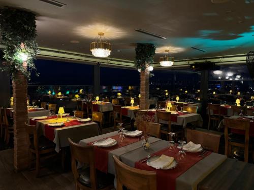 a restaurant with tables and chairs and lights at The Byzantium Suites Hotel & Spa in Istanbul