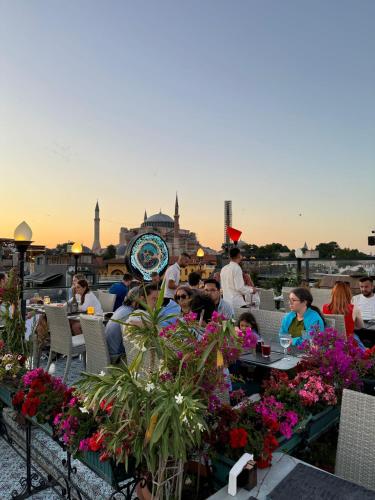 a group of people sitting at a restaurant with a view of the city at The Byzantium Suites Hotel & Spa in Istanbul