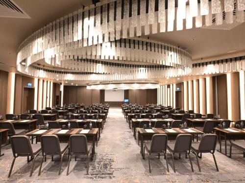 a large room with tables and chairs and a chandelier at Swissotel Uludag Bursa in Bursa