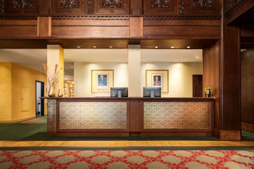 a lobby of a hotel with a reception desk at Vienna House by Wyndham Thüringer Hof Eisenach in Eisenach