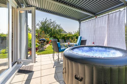 a hot tub on the patio of a house at Holiday Home Zala with Jacuzzi - Happy Rentals in Moravske Toplice
