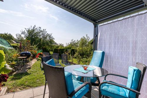 a patio with a table and chairs on a patio at Holiday Home Zala with Jacuzzi - Happy Rentals in Moravske Toplice