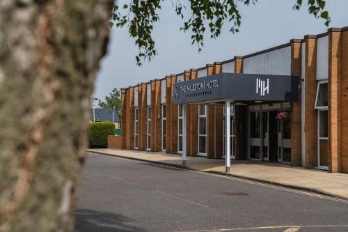 a building with a sign in front of it at Milestone Peterborough Hotel A1M, Sure Hotel Collection by Best Western in Peterborough