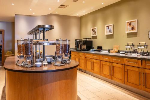 a large kitchen with a counter with food equipment at Milestone Peterborough Hotel A1M, Sure Hotel Collection by Best Western in Peterborough
