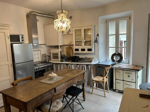 a kitchen with a wooden table and a dining room at Akasa on Lake Como in Menaggio