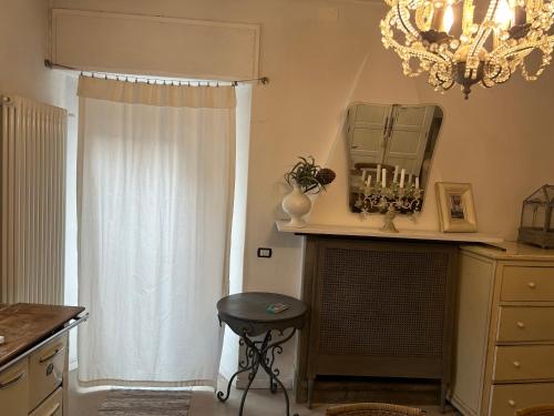 a kitchen with a chandelier and a stool in a room at Akasa on Lake Como in Menaggio
