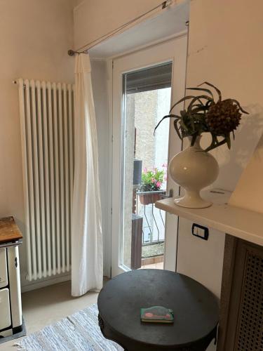a living room with a table and a window at Akasa on Lake Como in Menaggio