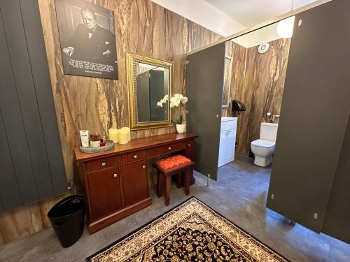 a bathroom with a sink and a mirror and a toilet at Dunningwell Hall in Duddon