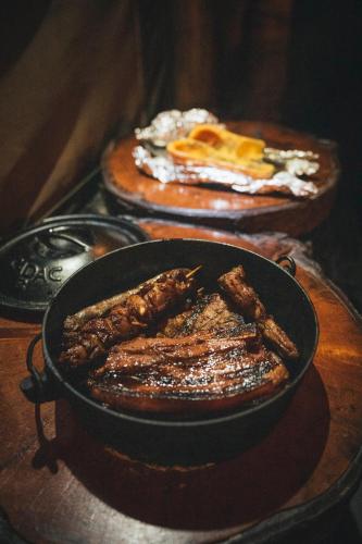 a pan of food sitting on top of a table at Quatermain's 1920's Safari Camp – Amakhala Game Reserve in Amakhala Game Reserve