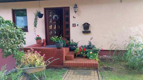 a house with potted plants on the front porch at Urlaub bei Umlauf in Heringsdorf