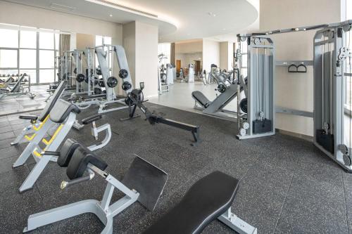 a gym with several treadmills and cardio machines at Hilton Brazzaville Les Tours Jumelles Hotel & Residences in Brazzaville