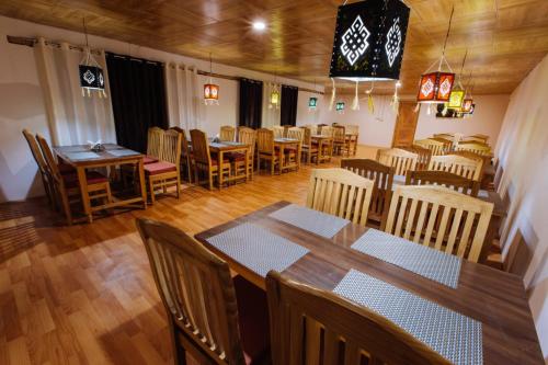 a dining room with wooden tables and chairs at Magpie Camp Ladakh by LexStays in Leh