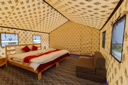 a bedroom with a bed in a tent at Magpie Camp Ladakh by LexStays in Leh