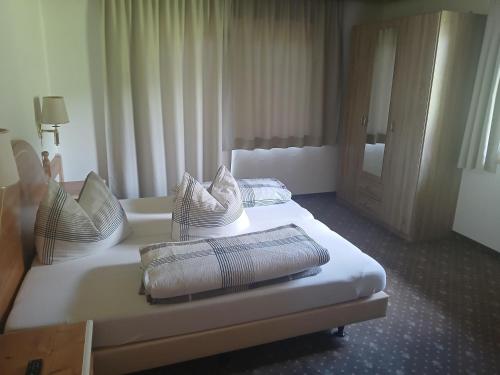 a hotel room with two beds with pillows on them at Goldmann, Haus in Tux