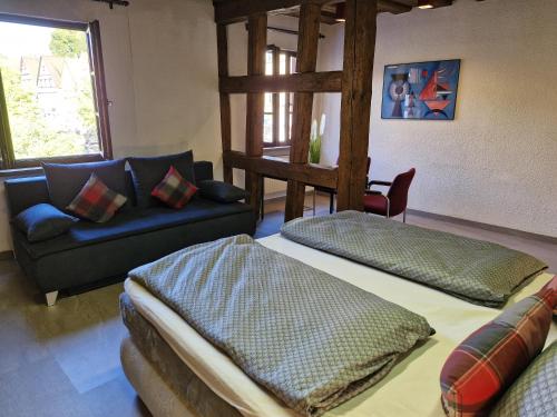 a living room with two beds and a couch at Ferienwohnung Marktblick in Pottenstein