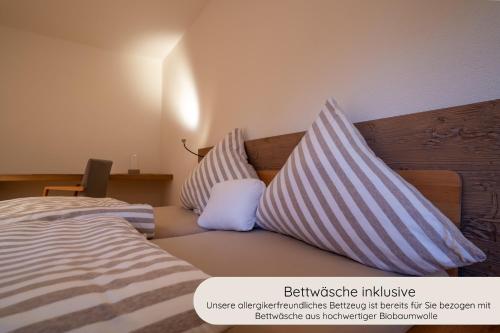 a bedroom with a bed with two pillows on it at INVITA Natur-Chalets - Familienurlaub im Schwarzwald in Bad Dürrheim