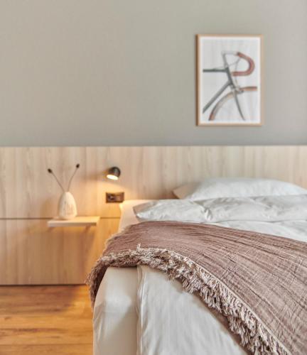 a bedroom with a bed and a picture on the wall at Hotel Balga Natur- und Bikehotel in Balgach