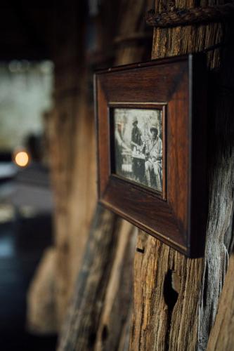 a picture of two people on a wooden wall at Quatermain's 1920's Safari Camp – Amakhala Game Reserve in Amakhala Game Reserve