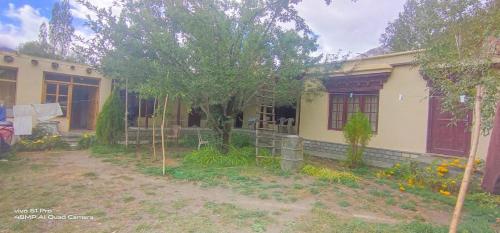 a house with a tree in front of it at Royal Mount Guest House Ladakh by LexStays in Leh