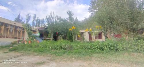 a house with a lot of flowers in front of it at Royal Mount Guest House Ladakh by LexStays in Leh