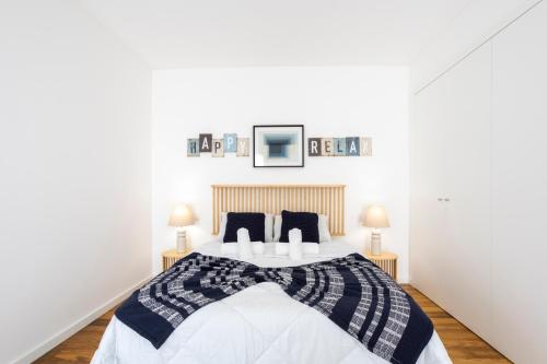 a bedroom with a large bed with two pillows at Stylish 3-Bedroom Villa Haven with a Private Pool in Albufeira